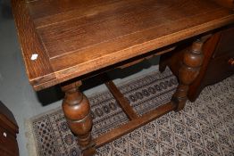 A mid 20th Century oak drawer leaf dining table having bulbous legs