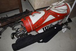 A selection of traditional golf clubs, in Wilson golf bag, and similar clubs