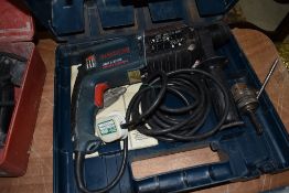 A cased Bosch hammer drill