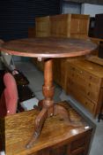 A C19th oak tripod table having circular top, on triple splay legs