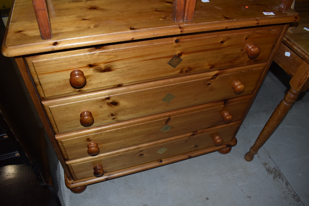 A modern pine chest of four long bedroom drawers