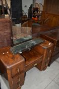 A mid 20th Century walnut dressing table having Art Deco style handles