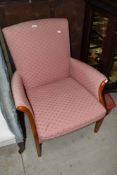 A mid C20th Parker Knoll upholstered armchair having wood detail