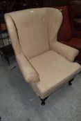 A reproduction period style wing back armchair on cabriole legs