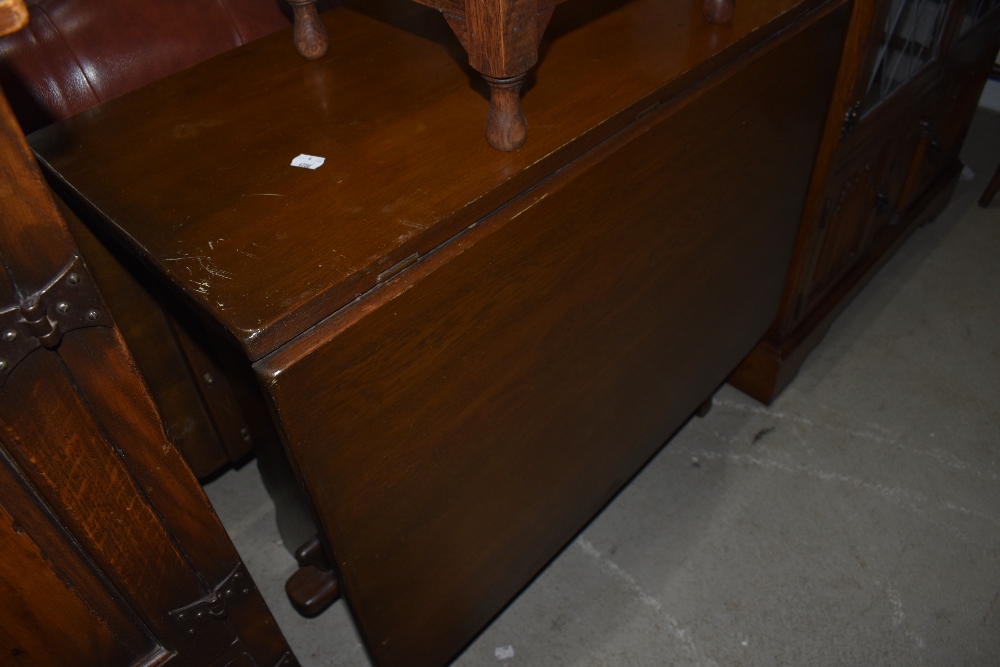 A mid/late 20th part oak drop leaf dining table on square gate legs, w 80cm