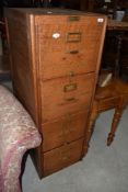 A traditional oak four drawer filing cabinet, brass label for Shaw Walker, London, brass handles