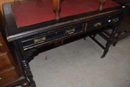 A late Victorian ebonized aesthetic design desk, having inset top, two drawers, and twist legs, w