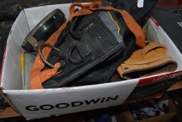 A box of miscellaneous tool belts etc