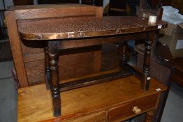 A traditional copper top coffee table