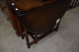 A mid 20th Century dark stained gateleg table, Ercol or similar