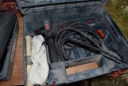 A cased Bosch hammer drill