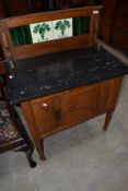 A Victorian tile and marble top washstand, having cupboard base and turned legs