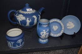 A Wedgwood teapot, a small pot and two plates.