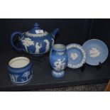 A Wedgwood teapot, a small pot and two plates.