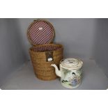 An unusual vintage hand painted oriental tea pot in padded basket.