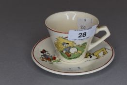 A childs cup and saucer by Meakin having Donald duck, jack and Pluto designs.
