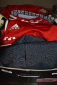 A box of sports wear including Liverpool football club jackets.