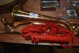 A military replica horn and a brass towel rail.