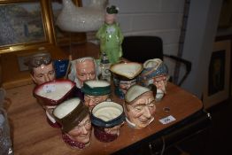 A collection of character jugs and Novelty hunter with rabbit bottle with shot glasses.