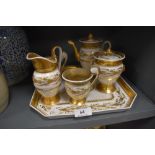 A 19th century hard paste bachelor set having tray,cups,jug,pot and sugar basin with lid,having