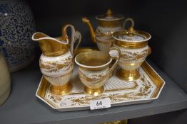 A 19th century hard paste bachelor set having tray,cups,jug,pot and sugar basin with lid,having