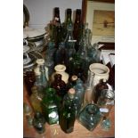 A collection of vintage glass and stoneware bottles and jars amongst which there are some of