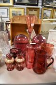 A selection of cranberry glass items including vase, bowl and glass