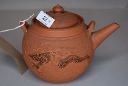 A 19th century Yixing day teapot having dragon decoration.