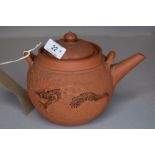 A 19th century Yixing day teapot having dragon decoration.