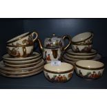 A Japanese Satsuma part tea set having hand painted scenes and gilt detailing, including tea pot,