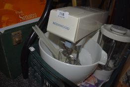 A vintage Kenwood mixer with whisk and K beater also blender attachment.