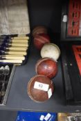 Five vintage leather cricket balls.