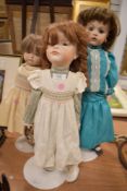 Three porcelain headed dolls