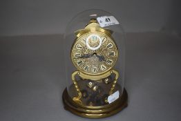 A glass domed anniversary clock by Kundo