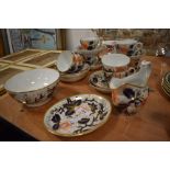 A 19th century part tea service in the Imari pallet comprising of cups and saucers, jug and sugar