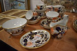 A 19th century part tea service in the Imari pallet comprising of cups and saucers, jug and sugar