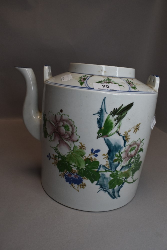 A large oriental tea pot having hand painted bird and floral design, missing lid.