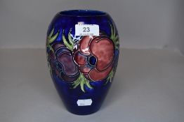 A vintage Moorcroft vase having cobalt blue ground and pattern of anemones.