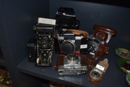 A selection of vintage cameras including Praktika super TL and butchers Watch pocket carbine.