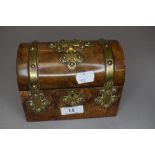 A pair of cut glass scent or perfume bottles in a miniature domed strong box chest with brass