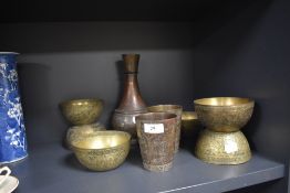 A selection of vintage brass ware having middle eastern designs, including vase and bowls.