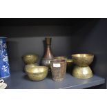 A selection of vintage brass ware having middle eastern designs, including vase and bowls.