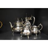 A four piece silver plated tea set of plain circular form having hoof feet