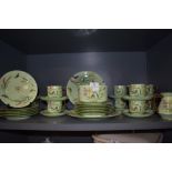 A 19th century partial dinner service in mint green having naturalistic design,indistinctly signed