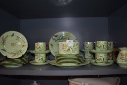 A 19th century partial dinner service in mint green having naturalistic design,indistinctly signed