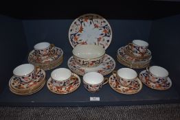 A part set of antique ceramics having Imari pallet and gilt detailing, including plates, cups and