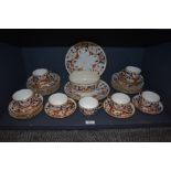 A part set of antique ceramics having Imari pallet and gilt detailing, including plates, cups and