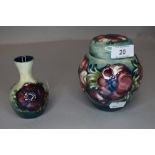 A Moorcroft ginger jar and a bud vase both having green ground with anemone pattern.