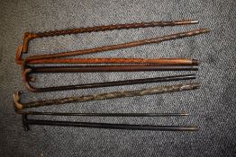 A selection of vintage sticks and walking canes.