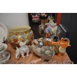 A selection of ceramics amongst which are a planter and elephant ornaments.